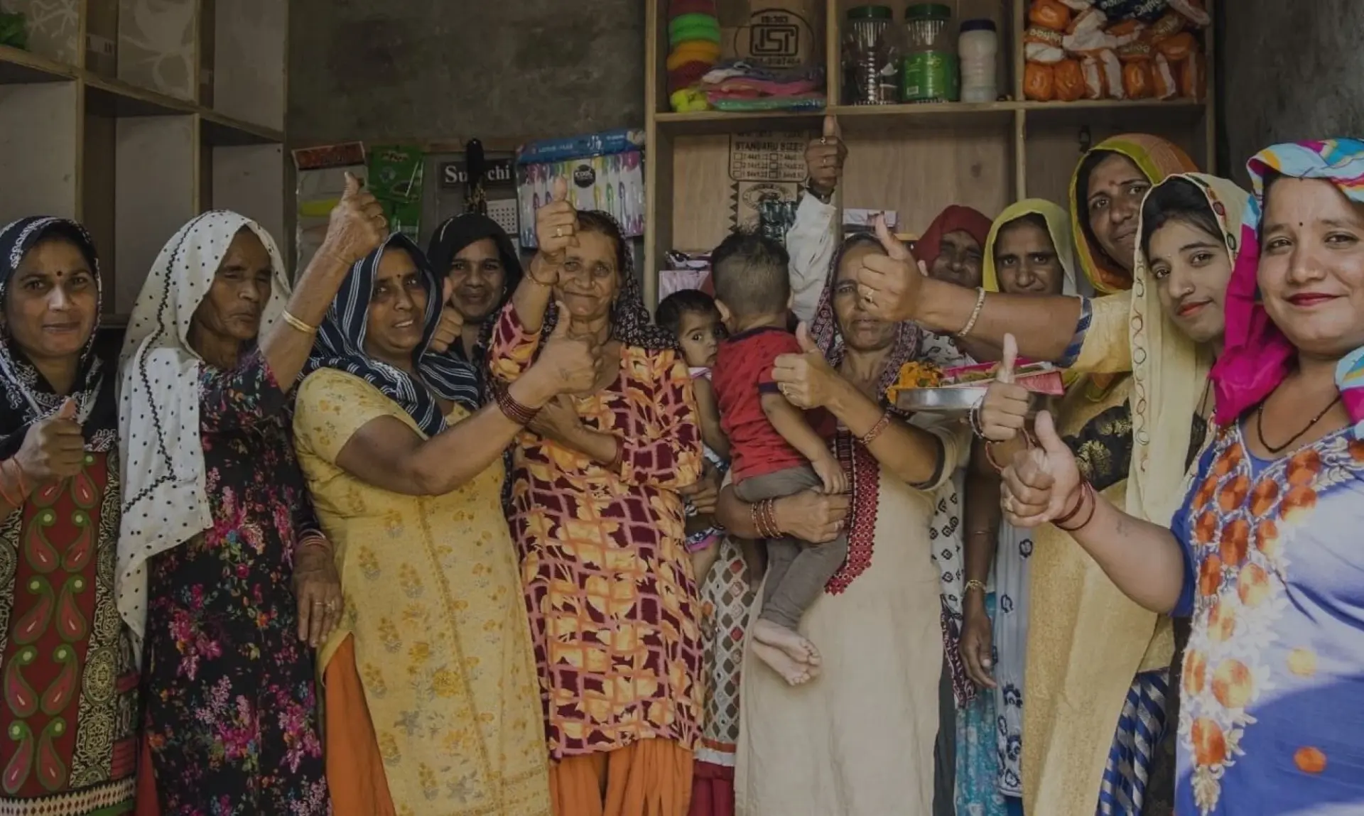Women entrepreneurs from a PURE India Trust self-help group celebrating outside their community store